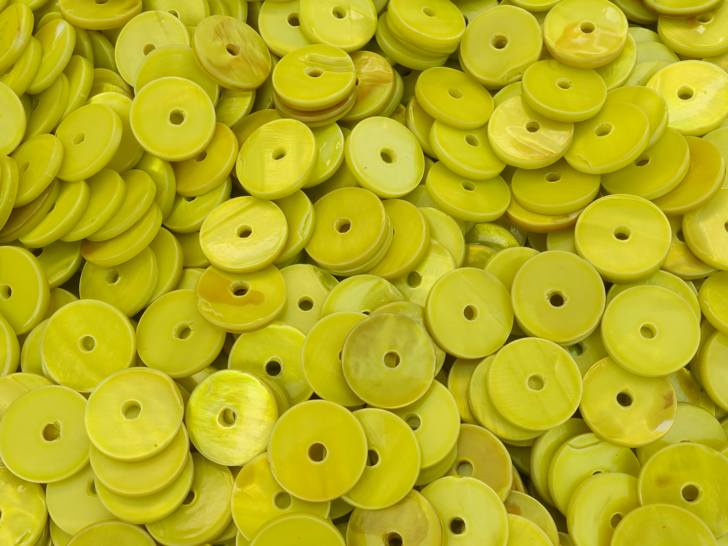 flat, green shell disc 12mm with a hole in the middle